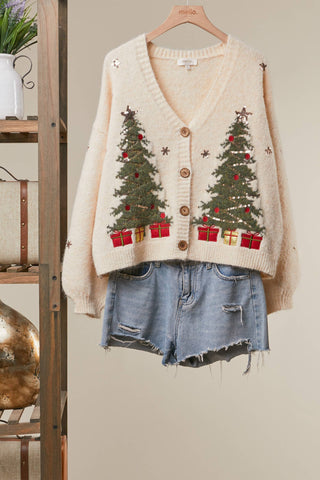 Under the Tree embroidered Christmas cardigan in cream with green trees and red gifts