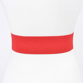 Close-up of gold metal flower buckle on red stretch belt