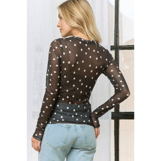 Sheer polka dot mesh long sleeve top styled with jeans
