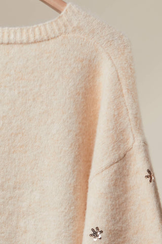 Soft fuzzy knit texture and snowflake embroidery on cardigan sleeve