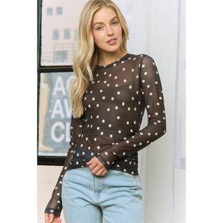 Sheer polka dot mesh long sleeve top styled with jeans