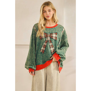 Front view of plaid bow applique sweatshirt with plaid side trim
