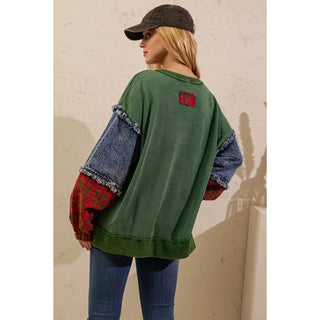 Back view of green pullover with denim and plaid patchwork sleeves