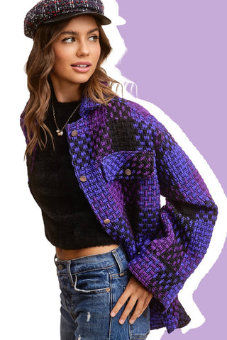 Purple check shacket worn open over a black top and jeans