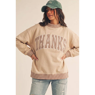 Front view of oversized gingham trim THANKS sweatshirt