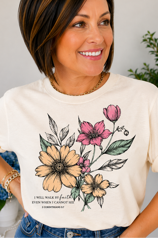 Woman wearing a white t-shirt with floral faith design and text