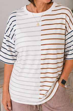 Person wearing a white and brown striped shirt with a neutral background