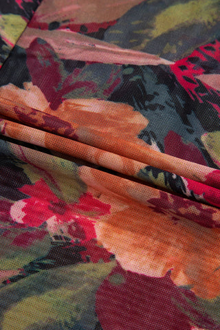 Close-up of stretch mesh fabric with painterly rust and crimson floral print