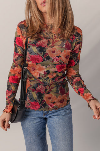 Autumn floral mesh top on model showing fitted silhouette and long sleeves