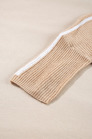 Detail of ribbed crew neckline on beige knit sweater