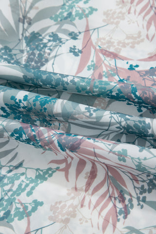Floral patterned fabric with pink, green, and gray colors.