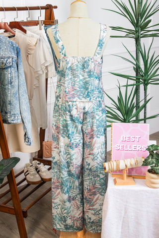 Floral jumpsuit on a mannequin with 'Best Sellers' sign in a store setting