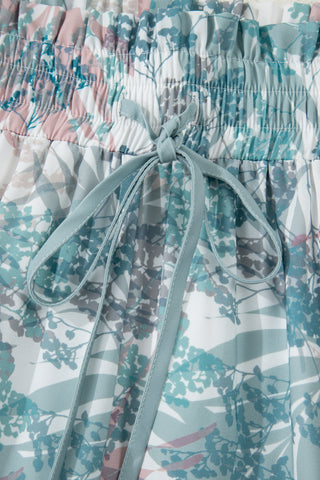 Floral patterned pants with a tie waist on a light background