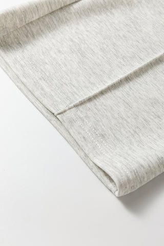 Close-up of a folded light gray fabric on a white background