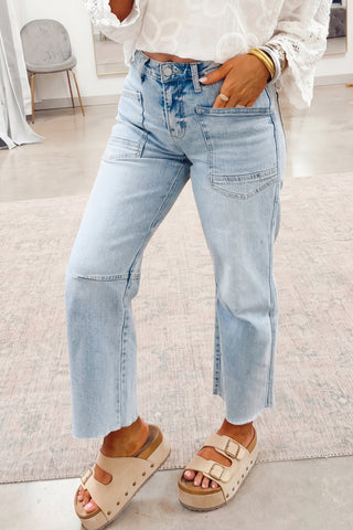 Person wearing light blue jeans and sandals indoors
