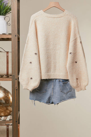 Back of cream Christmas cardigan with tiny embroidered snowflakes