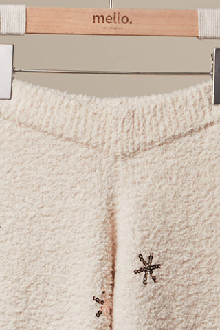 Close-up of fuzzy ivory knit sweater pants waistband