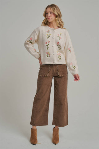 Milk chocolate corduroy wide leg pants styled with a cream floral cardigan and boots