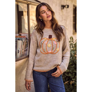 Side view of relaxed pumpkin sweater with blanket stitch cuffs