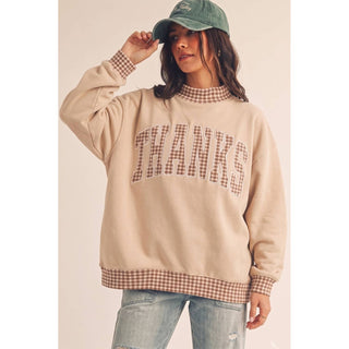 THANKS gingham patch pullover styled with jeans and a ball cap