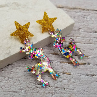 Side view of sparkly confetti reindeer Christmas earrings
