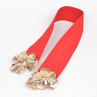 Red elastic belt laid open showing two gold flower clasp pieces