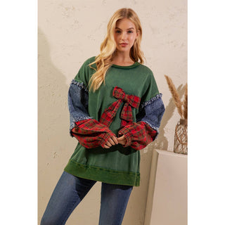 Front view of green plaid bow pullover with relaxed fit