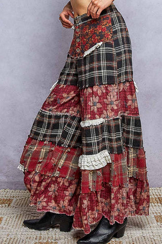 Side view of plaid and red floral patchwork wide leg pants with ruffle trim