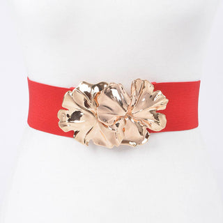 Side view of red stretch waist belt with gold metal flower clasp